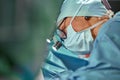 Close up portrait of female surgeon doctor wearing protective mask and hat during the operation. Healthcare, medical Royalty Free Stock Photo