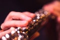 A close up portrait of fingers pressing down on the metal valves of a silver flute by a flutist playing the notes of a beautiful