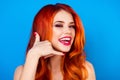 Close-up portrait of funny attractive pretty girl with long ginger fair hair show gesture call me back with fingers near