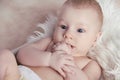 Close-up of Portrait funny baby lick his fingers o Royalty Free Stock Photo