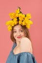 Close up portrait of funny beautiful young woman with flowers on her head isolated on pink background. Vertical frame Royalty Free Stock Photo