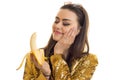 A close-up portrait of funny glamorous girl with banana in hand