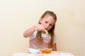 Jewish child dipping apple slices into honey on Rosh HaShanah. Royalty Free Stock Photo