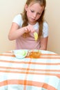 Jewish child dipping apple slices into honey on Rosh HaShanah. Royalty Free Stock Photo