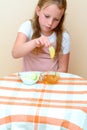 Jewish child dipping apple slices into honey on Rosh HaShanah.