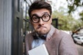 Close-up portrait of a funny nerd man wearing eyeglasses