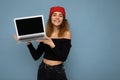 Close-up portrait of funny smiling happy beautiful dark blond young woman holding laptop computer looking at camera Royalty Free Stock Photo