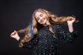 Close-up portrait gentle young caucasian girl with loose wavy hair on a black