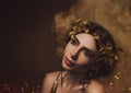 Close-up portrait. Girl with creative make-up and with golden eyelashes. The Greek goddess in a laurel wreath with Royalty Free Stock Photo