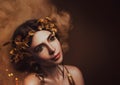 Close-up portrait. Girl with creative make-up and with golden eyelashes. The Greek goddess in a laurel wreath with Royalty Free Stock Photo