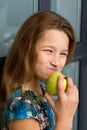 Close up portrait of girl eating apple. Royalty Free Stock Photo