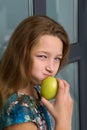 Close up portrait of girl eating apple. Royalty Free Stock Photo