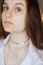 A close-up portrait of a girl with gray eyes. The girl hair is dark.