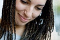 Close-up of girl\'s face, holding laughter, box-braids, freckles