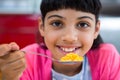 Close-up of portrait of girl holding cereal in spoon Royalty Free Stock Photo