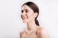 Close-up portrait of girl with perfect clear skin and shiny healthy hair, posing with snow-white smile on isolated Royalty Free Stock Photo