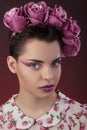 Close-up portrait  girl with a pink lipstick and shadows for eyes and a wreath on his head. Royalty Free Stock Photo