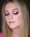 Close-up portrait of a girl with pink makeup