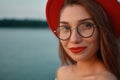 Close-up portrait girl with red lips, glasses and hat Royalty Free Stock Photo