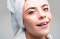 Close up portrait girl with towel on head. Portrait of beauty woman with eye patches showing an effect of perfect skin Royalty Free Stock Photo