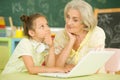 Portrait of grandmother and granddaughter using laptop