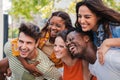 Close up portrait of a group of smiling multiracial teenage friends having fun outdoors. Cherful young people laughing Royalty Free Stock Photo