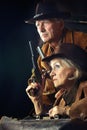 Portrait of gunslingers in western garment on black Royalty Free Stock Photo