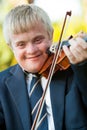 Close up portrait of handicapped boy with violin. Royalty Free Stock Photo