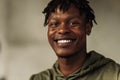 Close-up portrait of a handsome African American man smiling and looking at the camera. cheerful, positive, man`s look Royalty Free Stock Photo