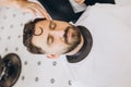 Close-up portrait of handsome bearded man at the barbershop, indoor. Beauty, selfcare, style, fashion, healthcare and
