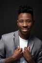 Close-up portrait of handsome black man with charming smile. Studio shot of well-dressed african guy wears white T-shirt