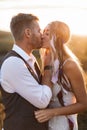 Close up portrait of handsome blond man and pretty woman in stylish boho rustic clothes, kissing. Lovely couple in eco Royalty Free Stock Photo