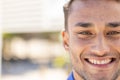 Close-up portrait of handsome caucasian young man with brown eyes smiling and looking at camera Royalty Free Stock Photo