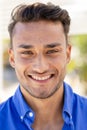 Close-up portrait of handsome caucasian young man with brown eyes smiling and looking at camera Royalty Free Stock Photo