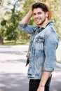 Close-up portrait of a handsome guy holding camera outdoors Royalty Free Stock Photo