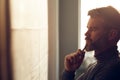 Close-up portrait of handsome man concentrated on work. Architect working in office with blueprints. Engineer sketching Royalty Free Stock Photo