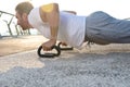 Close-up portrait of a handsome middle aged Caucasian man, muscular build athlete doing push ups during an outdoor workout on the Royalty Free Stock Photo