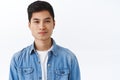 Close-up portrait of handsome stylish asian hipster, man with earring smiling pleased camera, looking enthusiastic and