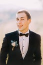 Close up portrait of handsome stylish groom outdoor with black tuxedo and bowtie Royalty Free Stock Photo