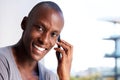 Close up handsome young african american man talking on mobile phone and smiling Royalty Free Stock Photo