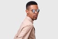 Close up portrait of handsome young African American man wearing round mirror sunglasses and casual beige shirt, looking to the Royalty Free Stock Photo