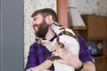 Close up portrait handsome young hipster man plays and loves his good friend dog at home. Positive human emotions Royalty Free Stock Photo
