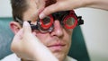 close-up, portrait of Handsome young man trying on blue sunglasses at optical store, optician retail store. in glasses