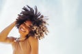 Close up portrait of happy african american female teenage smiling sweetly at the camera. Mixed race black girl with afro curls Royalty Free Stock Photo