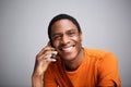 Close up happy african american man talking on cellphone against gray background Royalty Free Stock Photo