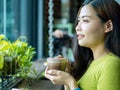 Close-Up Portrait of a Happy Asian woman with a Latte at the Cafe Royalty Free Stock Photo