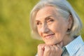 Close up portrait of happy beautiful elderly woman posing outdoors Royalty Free Stock Photo