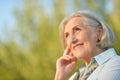 Portrait of happy beautiful elderly woman posing outdoors Royalty Free Stock Photo