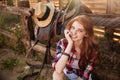 Close up portrait of a happy beautiful redhead cowgirl resting Royalty Free Stock Photo