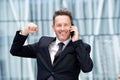 Close up happy business man on talking on phone with hand raised Royalty Free Stock Photo